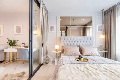 Luxurious bedroom with elegant decor and cozy ambiance, featuring plush bedding and stylish lighting.