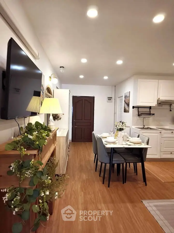Charming open-layout living and dining area with modern kitchen, perfect for cozy gatherings.