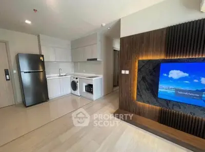 Modern open-plan kitchen and living area with sleek appliances and stylish decor