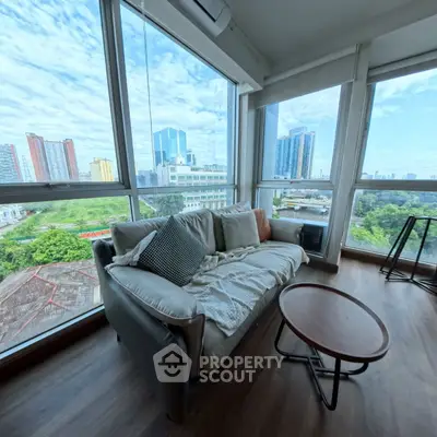 Spacious living room with panoramic city view and modern furnishings