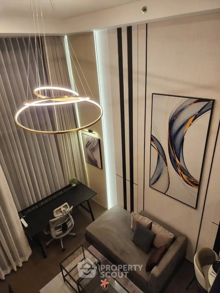 Modern living room with high ceilings, stylish chandelier, and contemporary art, perfect for urban living.