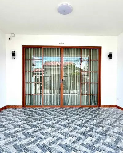 Elegant patio with sliding glass doors and stylish tile flooring