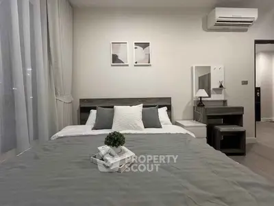 Modern bedroom with stylish decor and air conditioning in a cozy apartment.