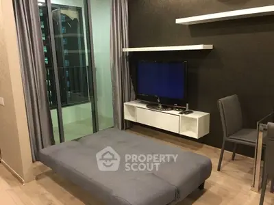 Modern living room with sleek furniture and balcony view in a stylish apartment.