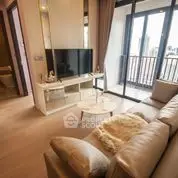 Modern living room with cozy sofa and large TV, featuring a balcony view.