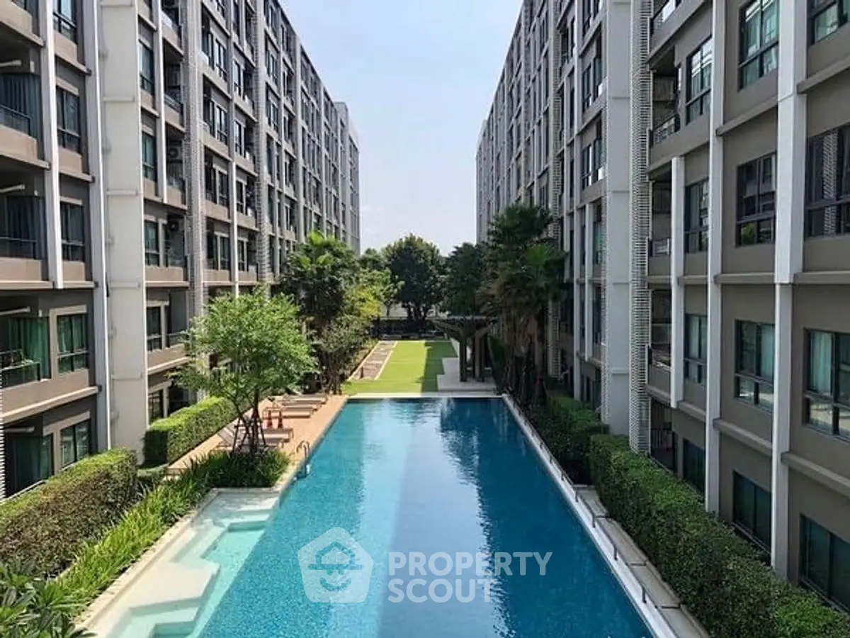 Luxurious apartment complex with stunning pool and lush greenery