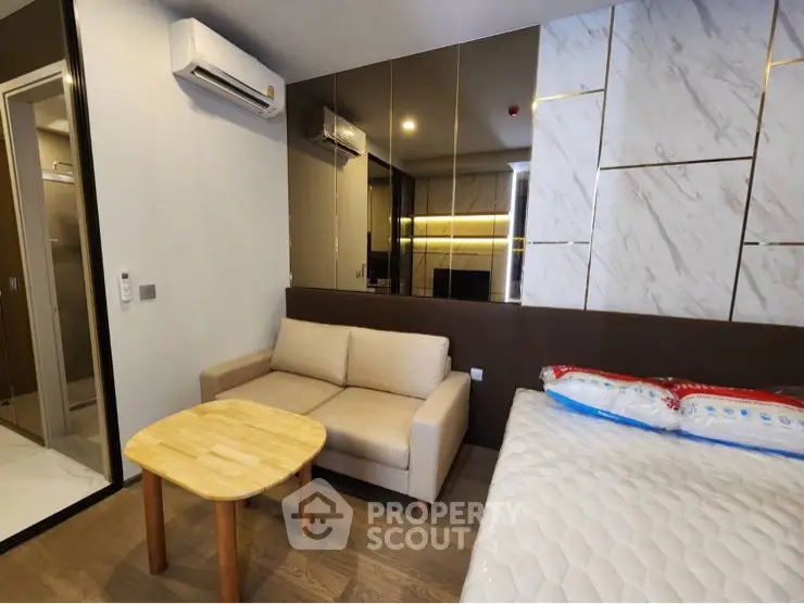 Modern studio apartment with cozy living area and stylish decor