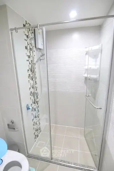 Modern bathroom with glass shower enclosure and stylish tile accents