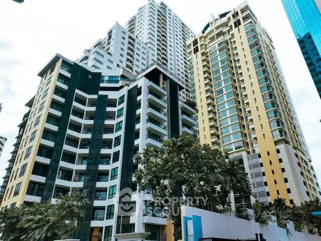 Stunning high-rise residential buildings with modern architecture and lush greenery in an urban setting.