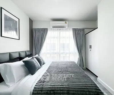 Modern bedroom with stylish decor and natural light in a contemporary apartment.