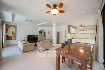 Spacious open-plan living room with modern kitchen and stylish decor.