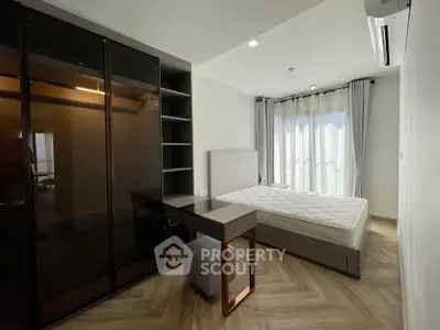 Modern bedroom with sleek furniture and large window for natural light