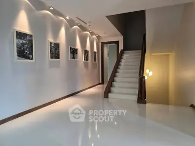 Elegant hallway with modern lighting and staircase in luxury property