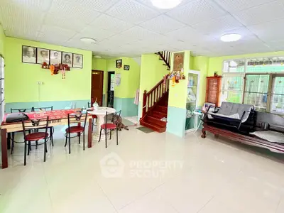 Spacious living room with bright decor and staircase in a cozy home
