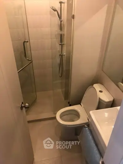 Compact modern bathroom with glass shower and sleek fixtures