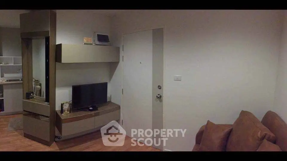 Cozy living room with modern entertainment unit and comfortable seating