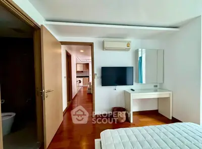 Modern bedroom with air conditioning and wooden flooring in a stylish apartment.
