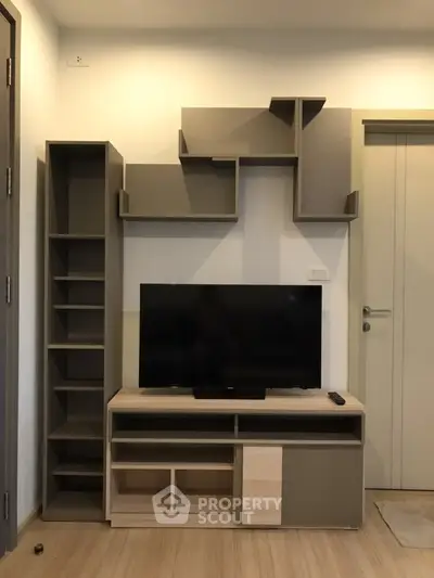 Modern living room with stylish TV unit and shelving, perfect for contemporary homes.