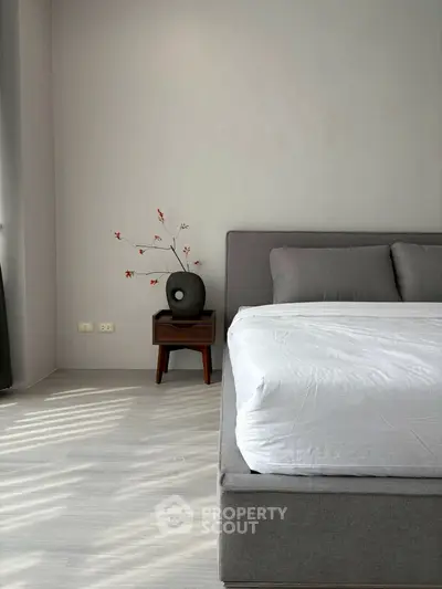 Modern bedroom with minimalist decor and stylish gray bed