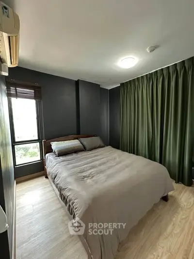 Modern bedroom with large window and stylish dark walls, featuring a cozy bed and elegant curtains.