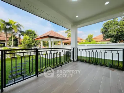 Charming balcony with garden view in a serene residential area.