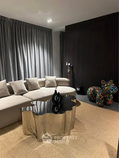 Luxurious modern living room with unique metallic coffee table and plush sectional sofa.