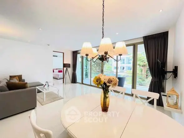 Spacious living room with elegant chandelier and garden view