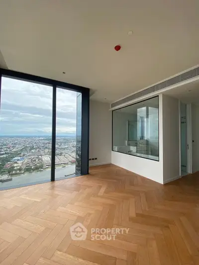 Luxurious high-rise apartment with stunning city view and elegant parquet flooring.