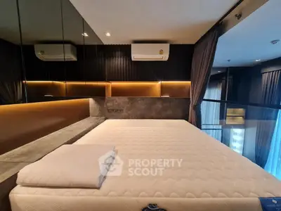 Luxurious modern bedroom with stylish lighting and air conditioning, perfect for comfort and relaxation.