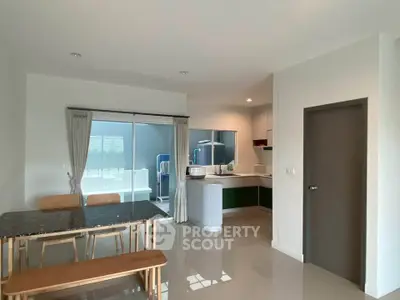 Modern open-plan kitchen and dining area with sleek design and ample natural light.