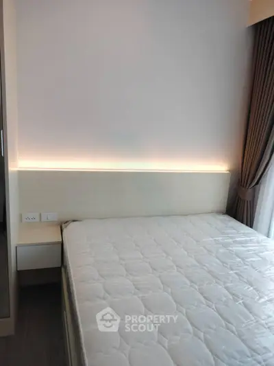 Modern bedroom with cozy lighting and elegant curtains, perfect for relaxation and comfort.