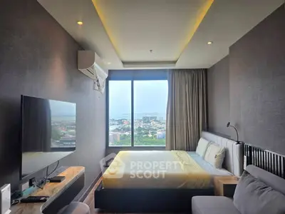Luxurious bedroom with stunning city view, modern decor, and large window for natural light.