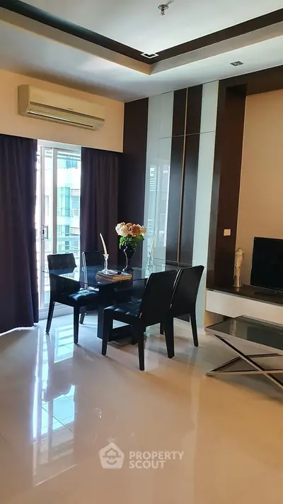 Modern living room with sleek furniture and large windows for natural light