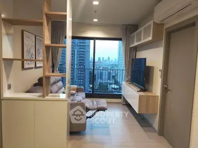 Modern living room with city view, featuring sleek furniture and large windows in a high-rise apartment.