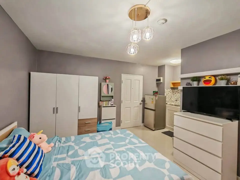 Cozy bedroom with modern decor and ample storage in a stylish apartment.