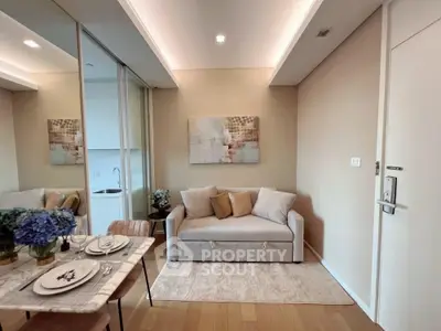 Modern living room with cozy sofa and elegant dining setup in a stylish apartment.