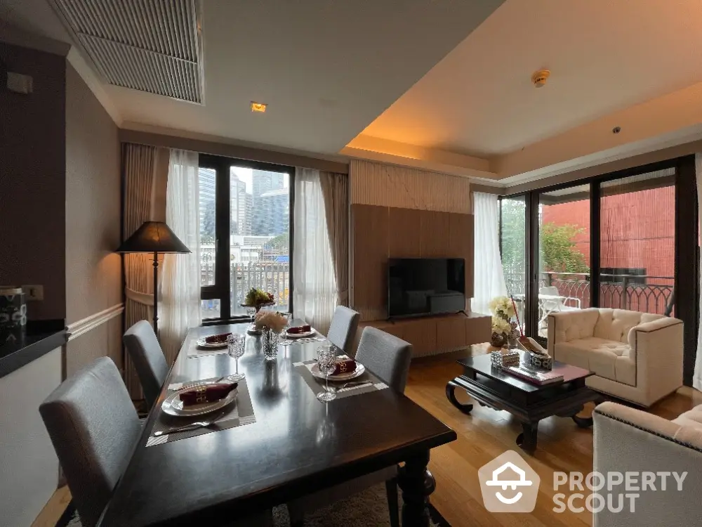 Luxurious open-plan living and dining area with city view, elegant furnishings, and natural light.