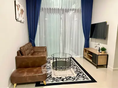Modern living room with leather sofa, glass coffee table, and wall-mounted TV, featuring elegant blue curtains.