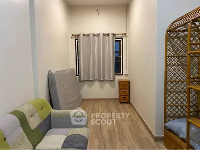 Cozy small living room with wooden flooring and simple furniture