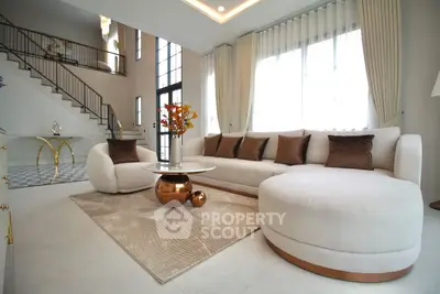 Luxurious modern living room with elegant furniture and large windows