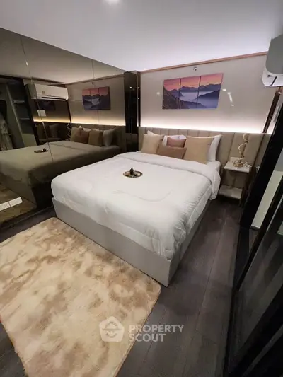 Luxurious bedroom with modern decor, plush bedding, and ambient lighting for ultimate comfort and relaxation.