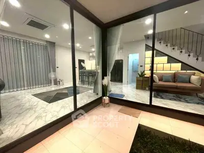 Modern open-plan living room with stylish decor and marble flooring