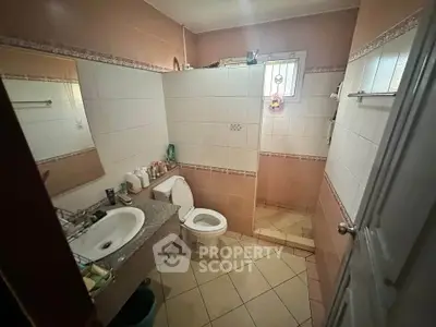 Cozy bathroom with tiled walls and modern fixtures