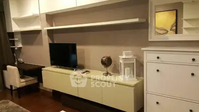 Modern living room with sleek furniture and wall-mounted TV