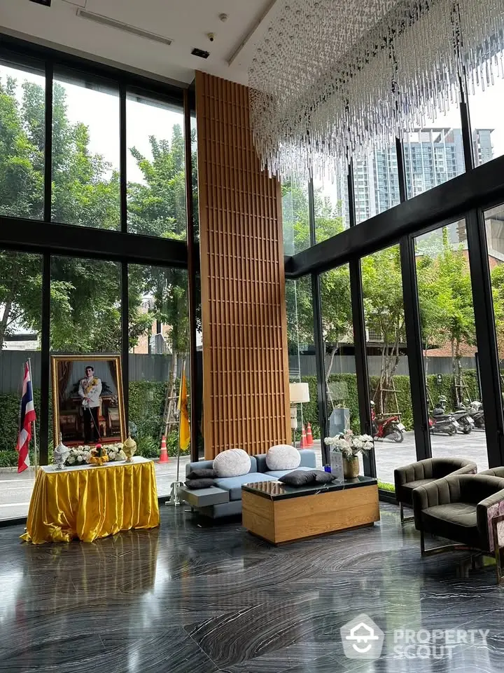 Luxurious modern lobby with floor-to-ceiling windows and elegant chandelier