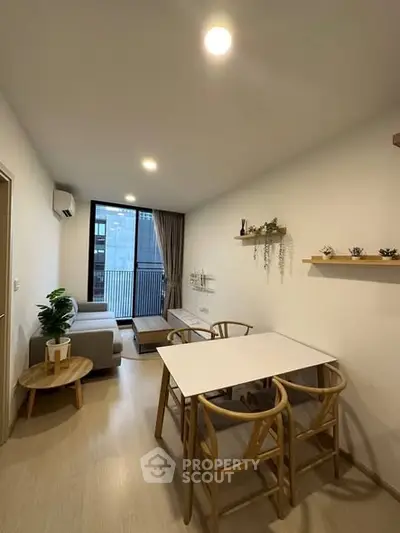 Modern living room with stylish furniture and balcony view in a contemporary apartment.