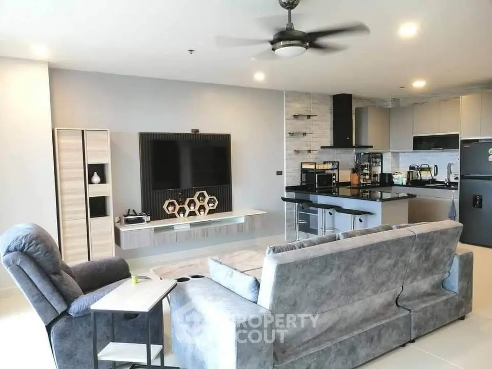 Modern open-layout living room with stylish kitchen and cozy seating area