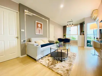 Modern living room with stylish decor and natural light, featuring a cozy sofa and chic coffee table.