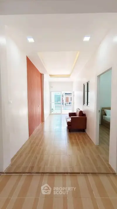 Spacious modern living room with elegant wooden flooring and cozy seating area.