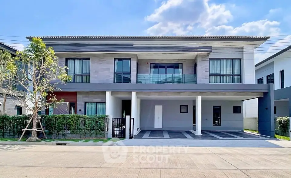 Modern two-story house with spacious balcony and sleek exterior design, perfect for contemporary living.